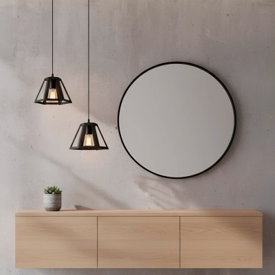 Espelho redondo com moldura preta acima de móvel de madeira clara e duas luminárias pendentes pretas