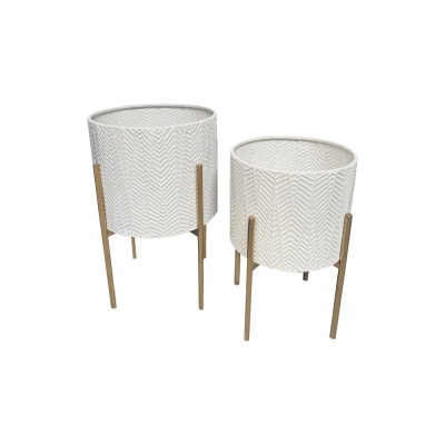 Conjunto dois vasos decorativos brancos com padrão em relevo e suporte metálico dourado.