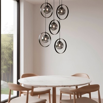 Mesa de jantar redonda em mármore branco com cadeiras de madeira clara estofadas e candeeiro pendente moderno de cinco lâmpadas