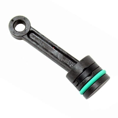 Peça mecânica preta com juntas tóricas verdes e pretas sobre fundo branco