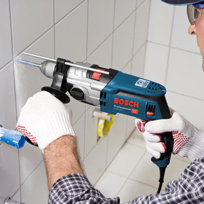 Máquina de perfuração Bosch Professional a perfurar azulejos brancos.