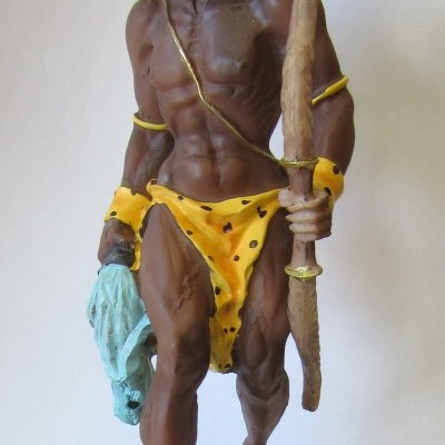 Estátua de Oxóssi em resina com vestuário amarelo e base com placa 'OXÓSSI'