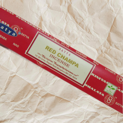 Embalagem vermelha de incenso Satya Red Champa sobre fundo de papel amassado
