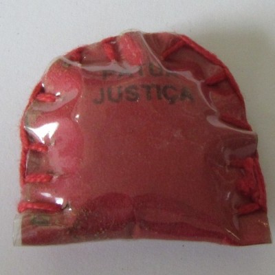 Capa vermelha com plástico transparente e a palavra JUSTIÇA impressa