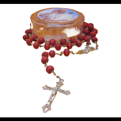 Terço com contas vermelhas e crucifixo dourado numa caixa transparente