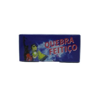 Caixa azul com texto 'QUEBRA FEITIÇO' e ilustração de uma figura assustadora iluminada.