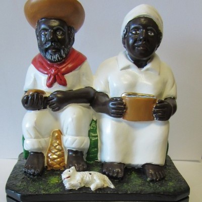 Escultura decorativa de casal afrodescendente sentado com cão e base preta
