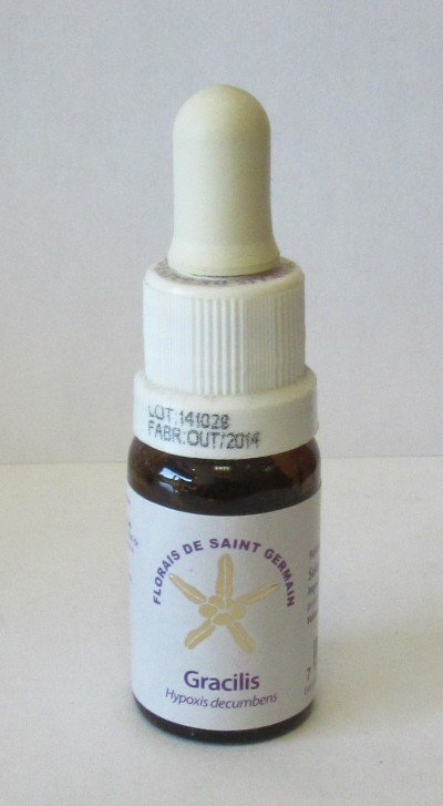 Frasco pequeno de vidro castanho com conta-gotas branco e rótulo com texto