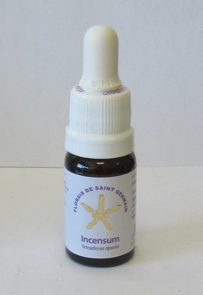 Frasco pequeno de vidro escuro com tampa branca e rótulo floral branco