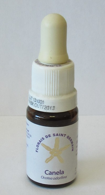 Frasco pequeno de vidro castanho com conta-gotas e etiqueta branca com texto roxo