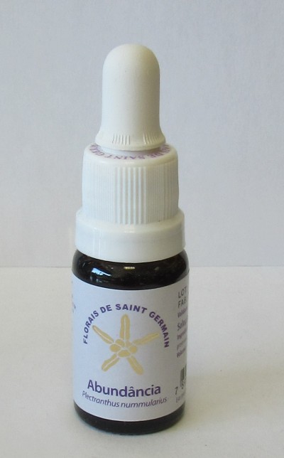 Frasco pequeno escuro com conta-gotas branco e etiqueta com texto 'Abundância'