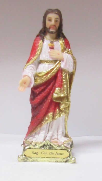 Estátua religiosa de Jesus Cristo com vestes coloridas e base dourada