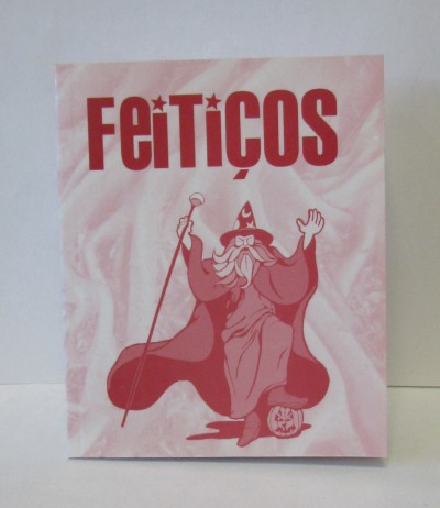 Capa rosa de livro ou revista com título FEITIÇOS e feiticeiro desenhado