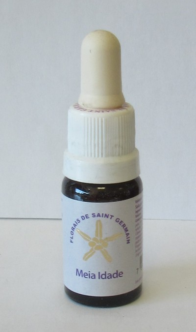 frasco de vidro escuro com conta-gotas branco creme e rótulo branco com texto e imagem de flor