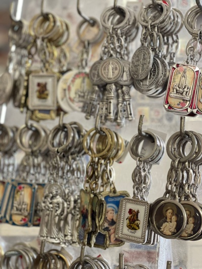 Chaveiros religiosos em metal com imagens de santos pendurados para venda