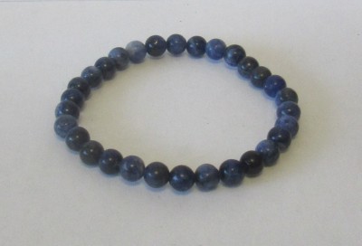 Pulseira com esferas azuis polidas sobre fundo branco