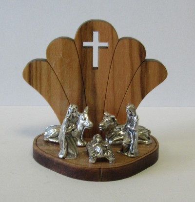 Presépio pequeno de madeira com figuras prateadas de Maria, José e Jesus e cruz no fundo