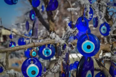 Amuletos do olho turco azuis pendurados em ramos com geada