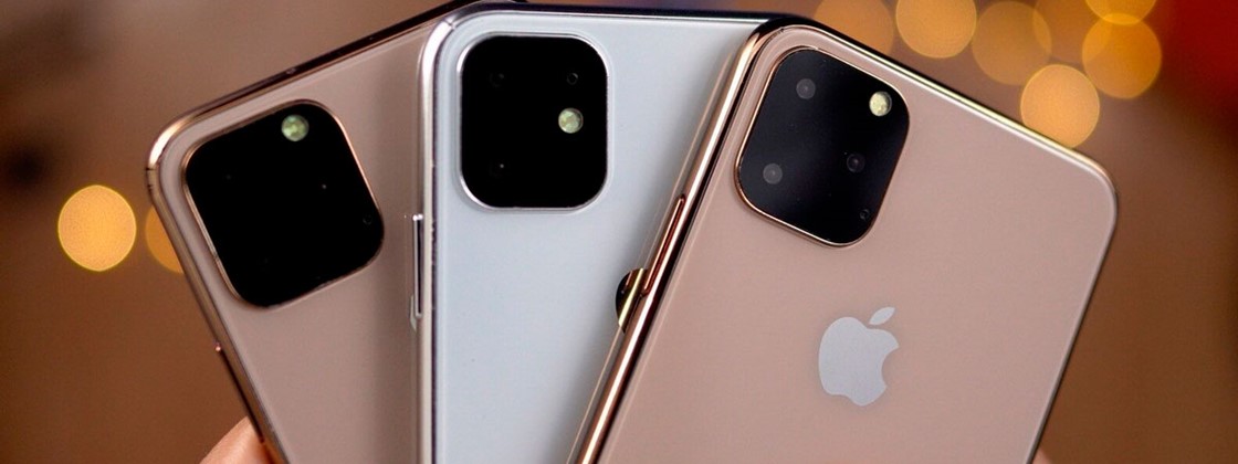 Três iPhones Apple em diferentes cores mostrando as câmaras traseiras e o logótipo