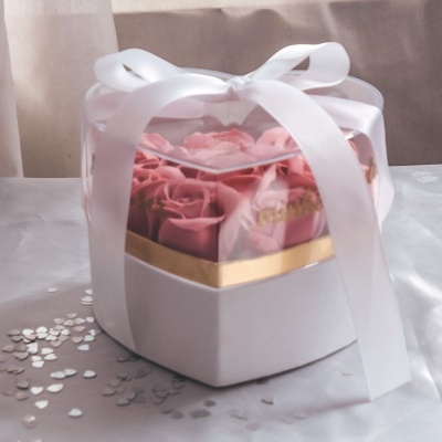 Caixa coração branca com flores rosa artificiais dentro e fita branca