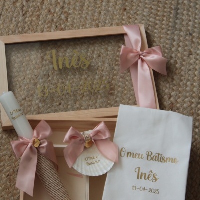 Conjunto de batismo com vela, toalha bordada e concha decorada dentro de caixa de madeira com tampa em vidro decorada com fita rosa.