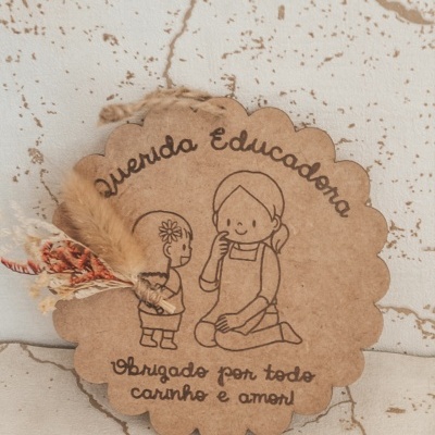 Etiqueta decorativa em papel castanho com ilustração e texto para educadora, decorada com flores secas.