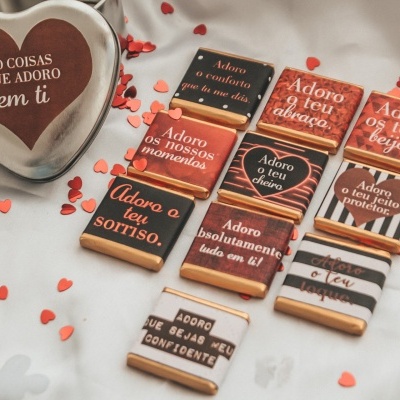 10 chocolates quadrados com mensagens em português e recipiente em forma de coração com frase