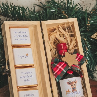 Caixa de madeira com chocolates e garrafa de presente de Natal decorada