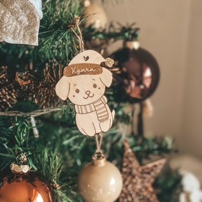 Enfeite madeira cão com nome Kyara numa árvore de Natal com bolas e estrela