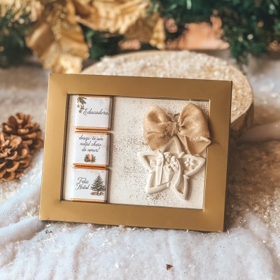 Caixa decorativa dourada com chocolates e estrela decorativa natalícia com laço dourado