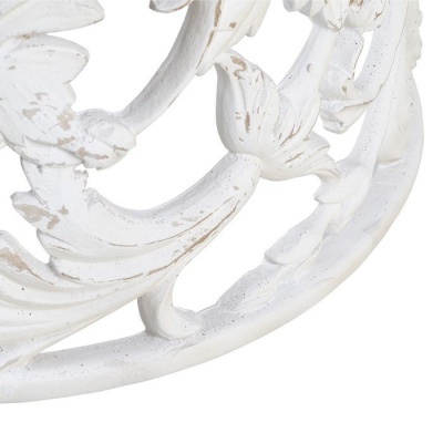 Detalhe de objeto decorativo branco envelhecido com padrões florais e folhas