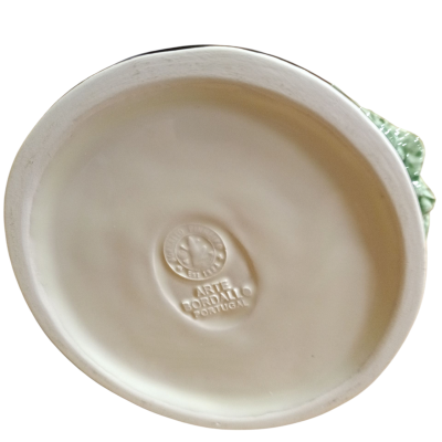 Base oval de cerâmica branca com inscrições em relevo no centro