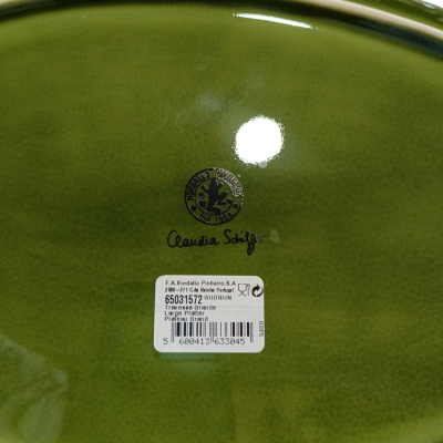 Base oval verde brilhante de cerâmica com etiqueta e texto