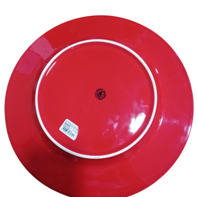 Prato cerâmico vermelho visto do avesso com etiqueta e carimbo