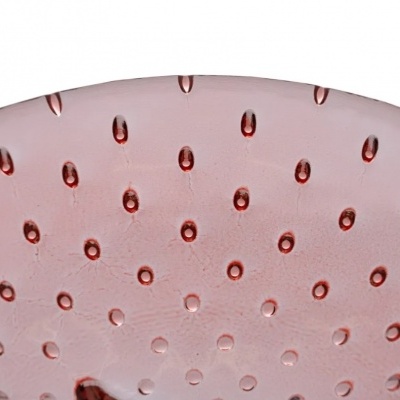 Superfície redonda cor-de-rosa com pontos em relevo