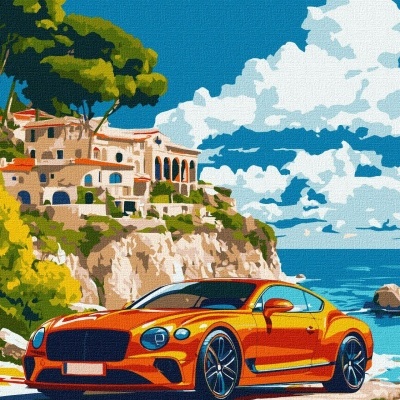 Carro desportivo laranja numa estrada costeira com falésia, casas e céu azul com nuvens.