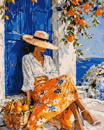 Mulher com chapéu de palha e saia florida sentada junto a porta azul numa cidade costeira