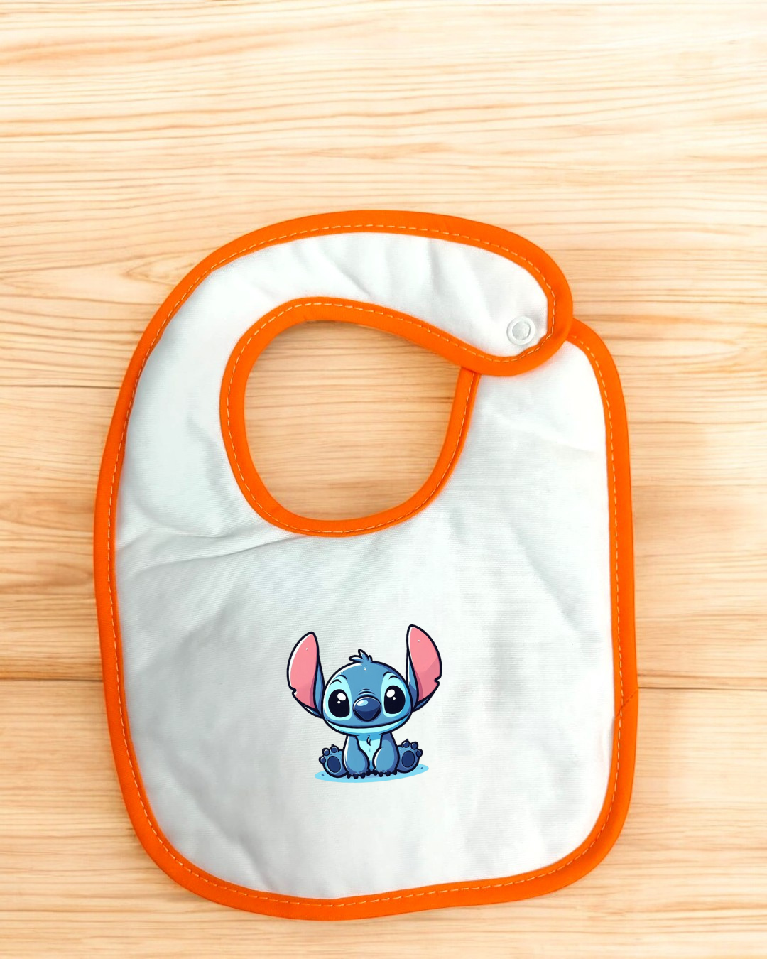 Babete branco com borda laranja e personagem Stitch azul