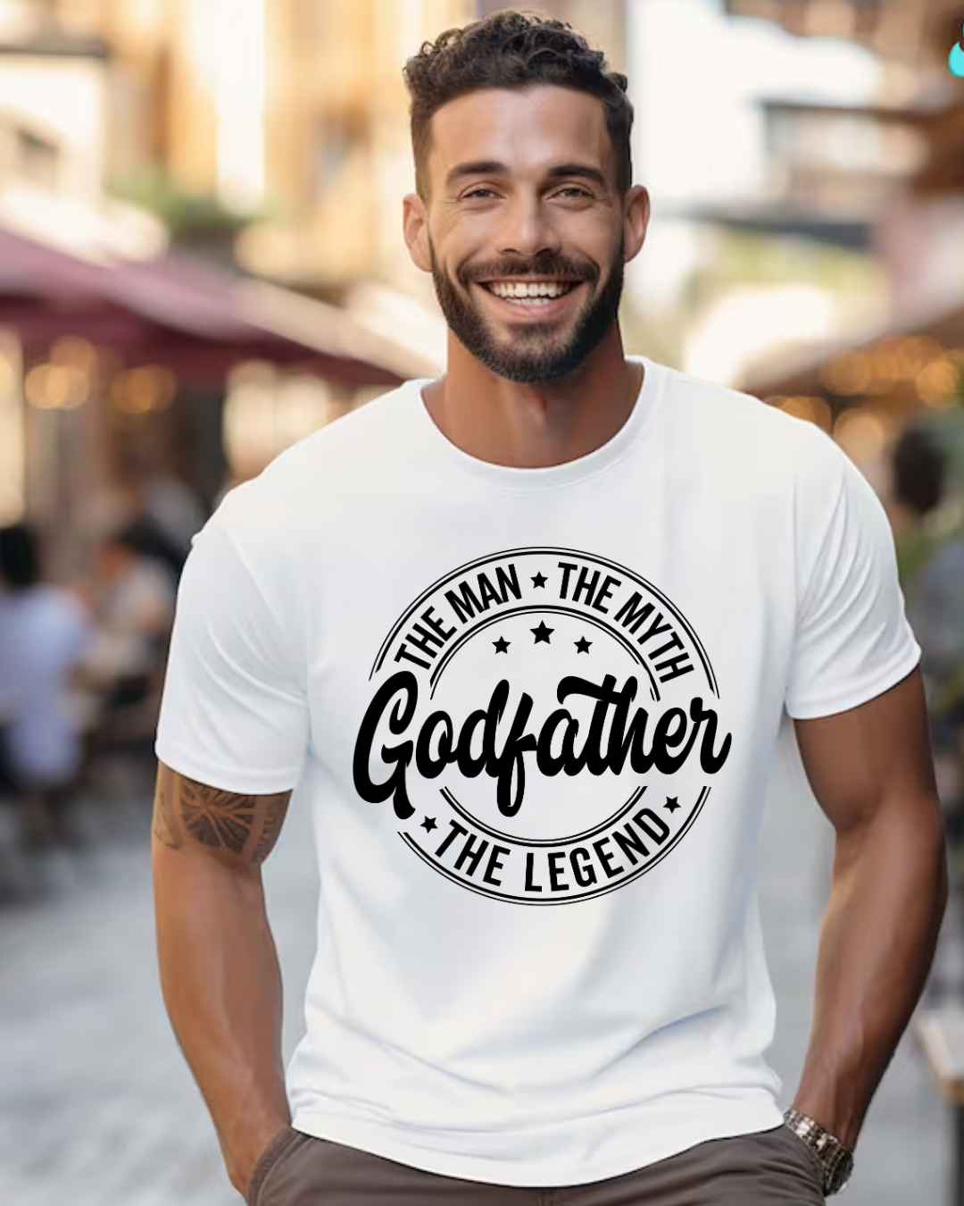 Homem sorridente com camiseta branca estampada com texto Godfather