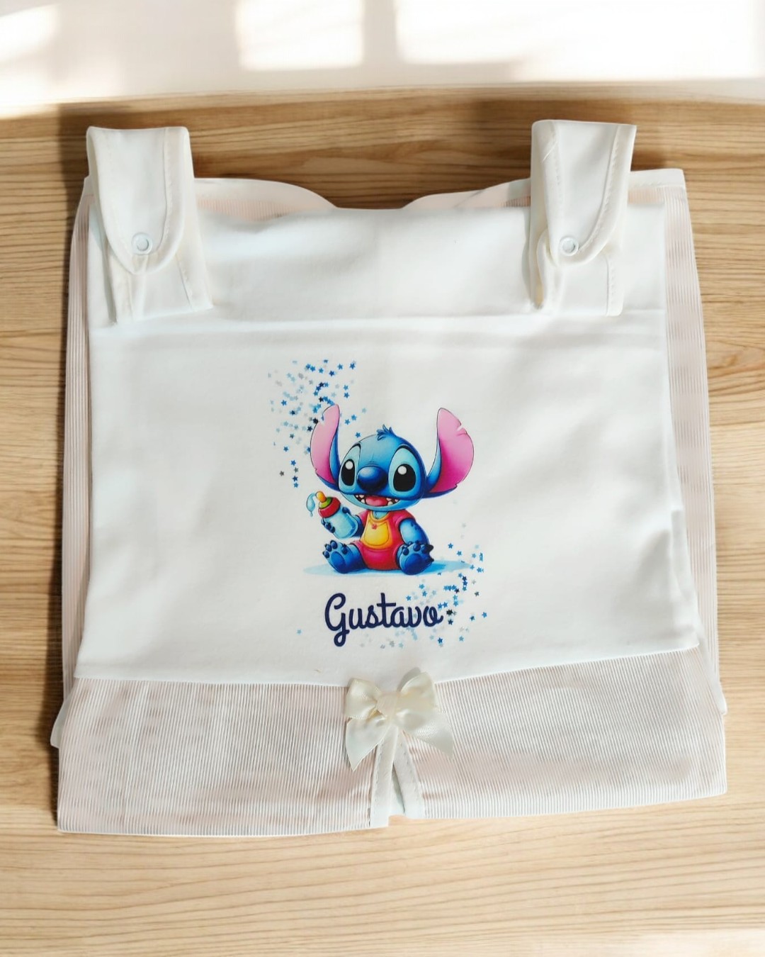 Toalha branca com ilustração colorida do personagem Stitch e nome Gustavo