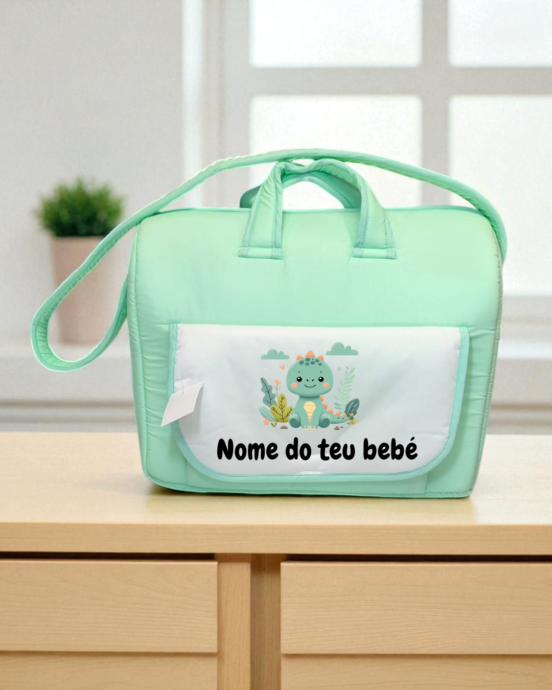 Mala de bebê verde menta com bolso branco e desenho de dinossauro