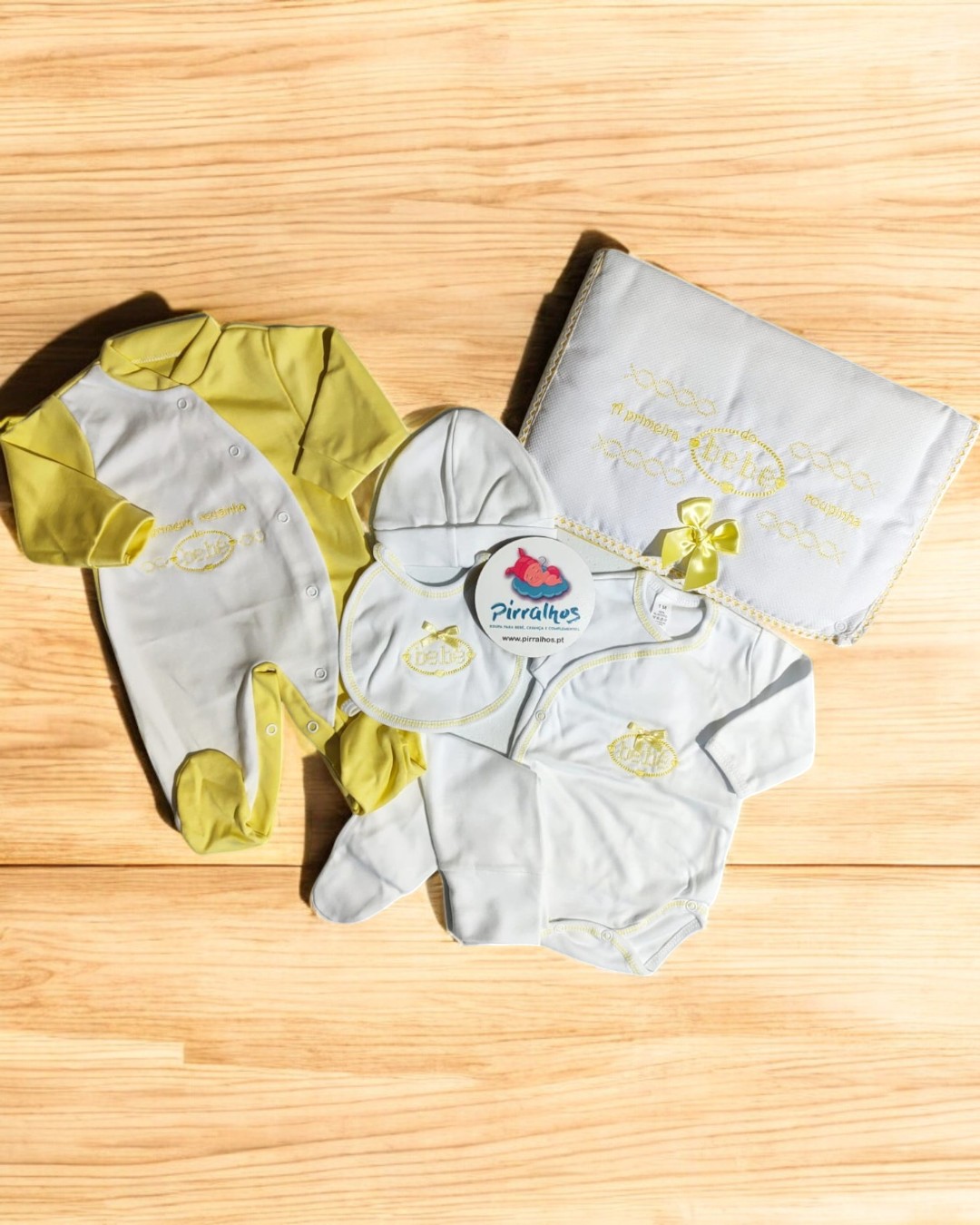 Conjunto de roupa de bebé branco e amarelo com macacão, body, babete e cobertor bordados