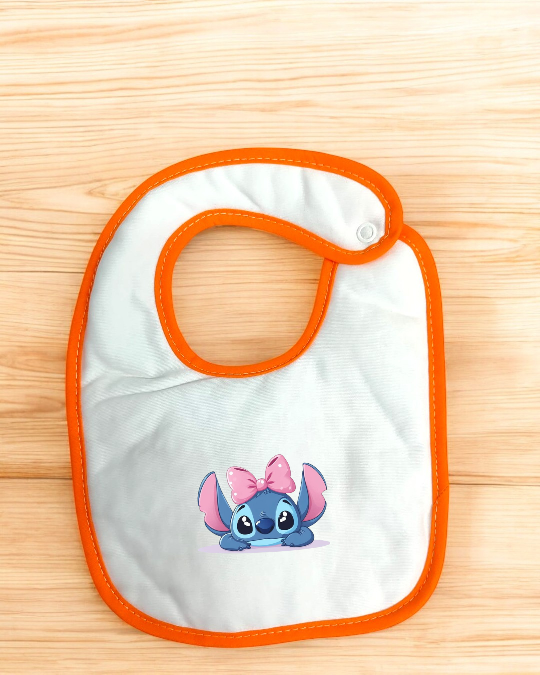 Babete branco com bordas laranja e estampa Stitch com laço cor-de-rosa