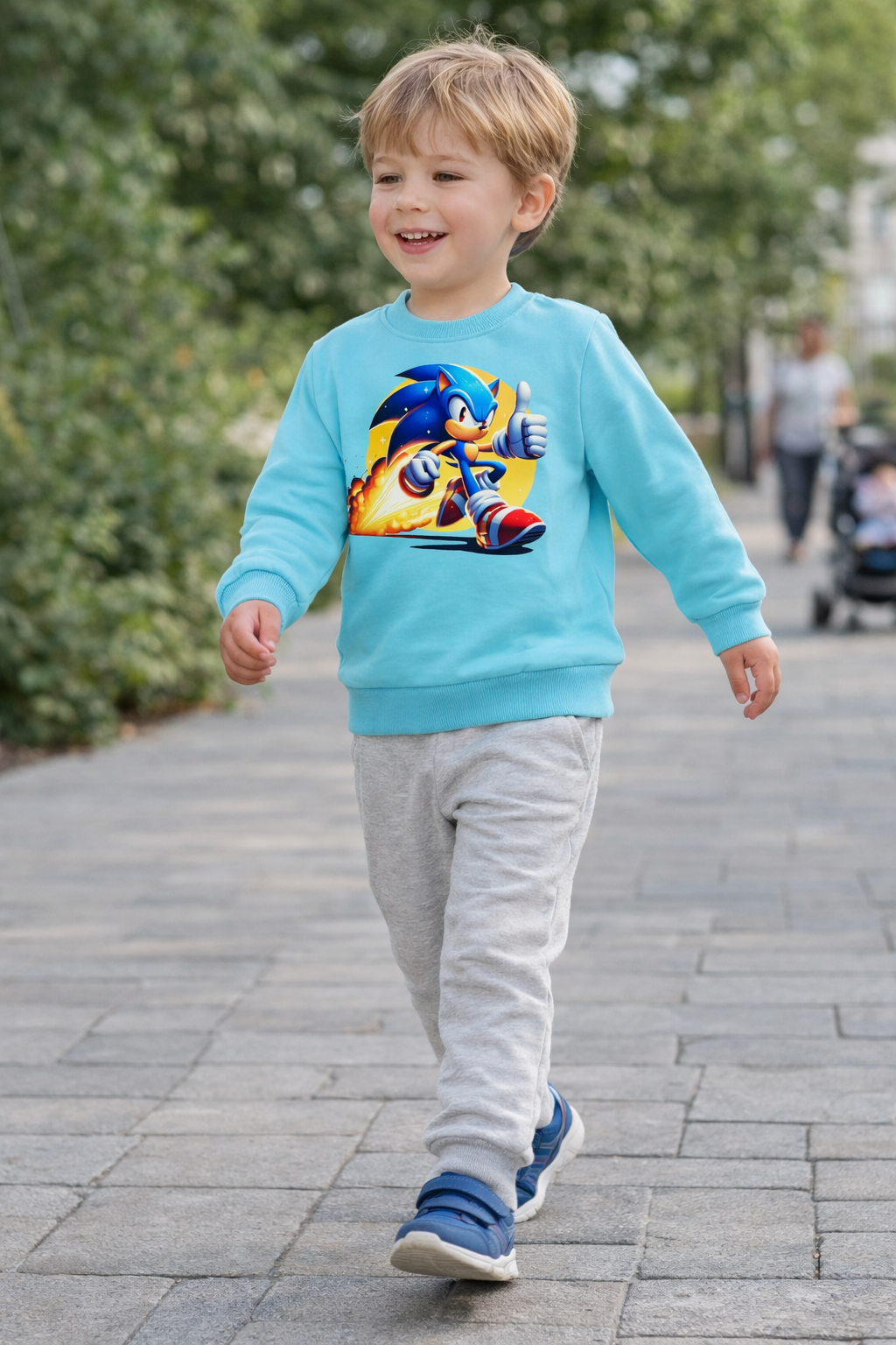 Criança a usar camisola azul com estampa do Sonic e calças cinza ao ar livre