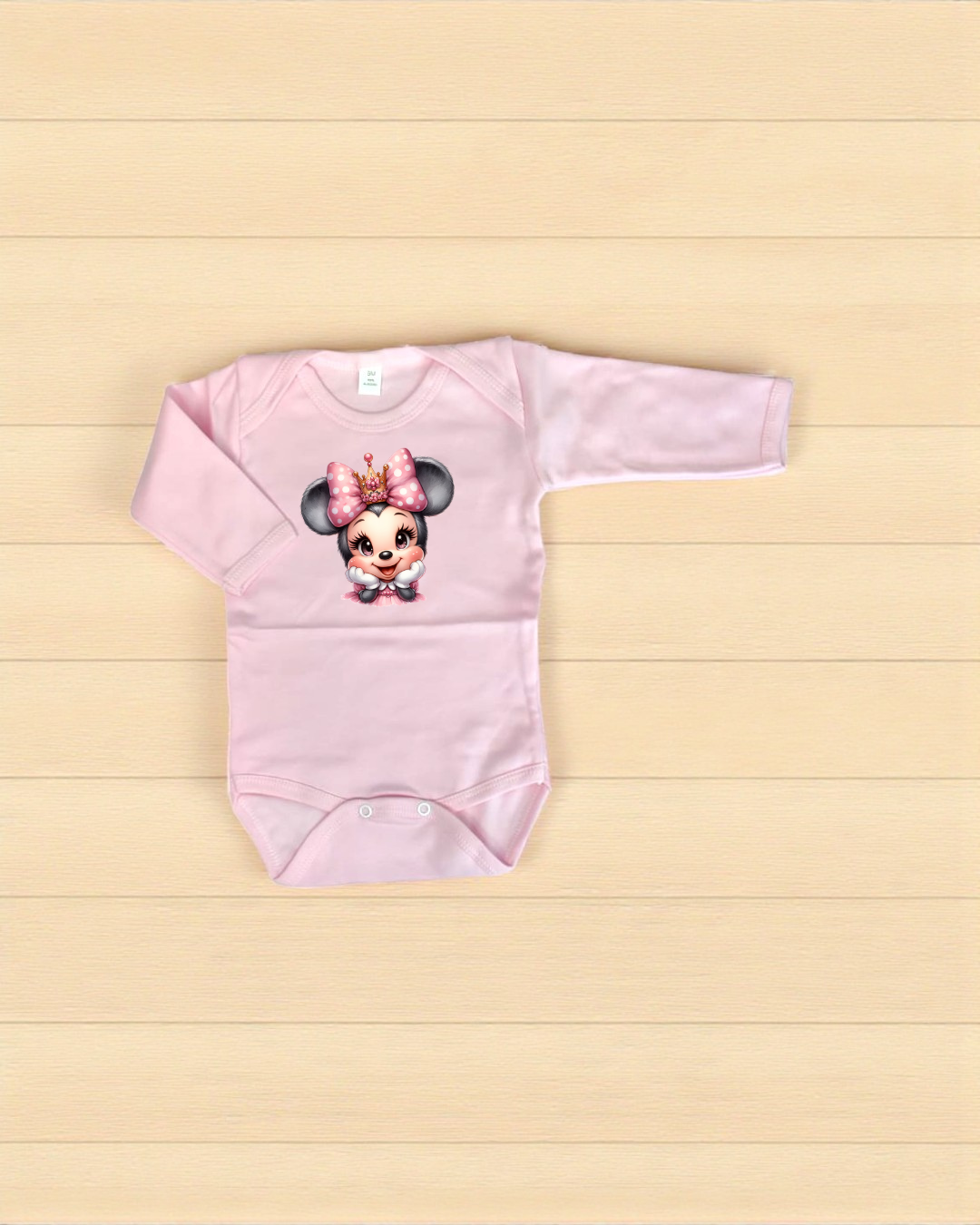 Body de bebé rosa com estampa Minnie Mouse e laço cor-de-rosa.