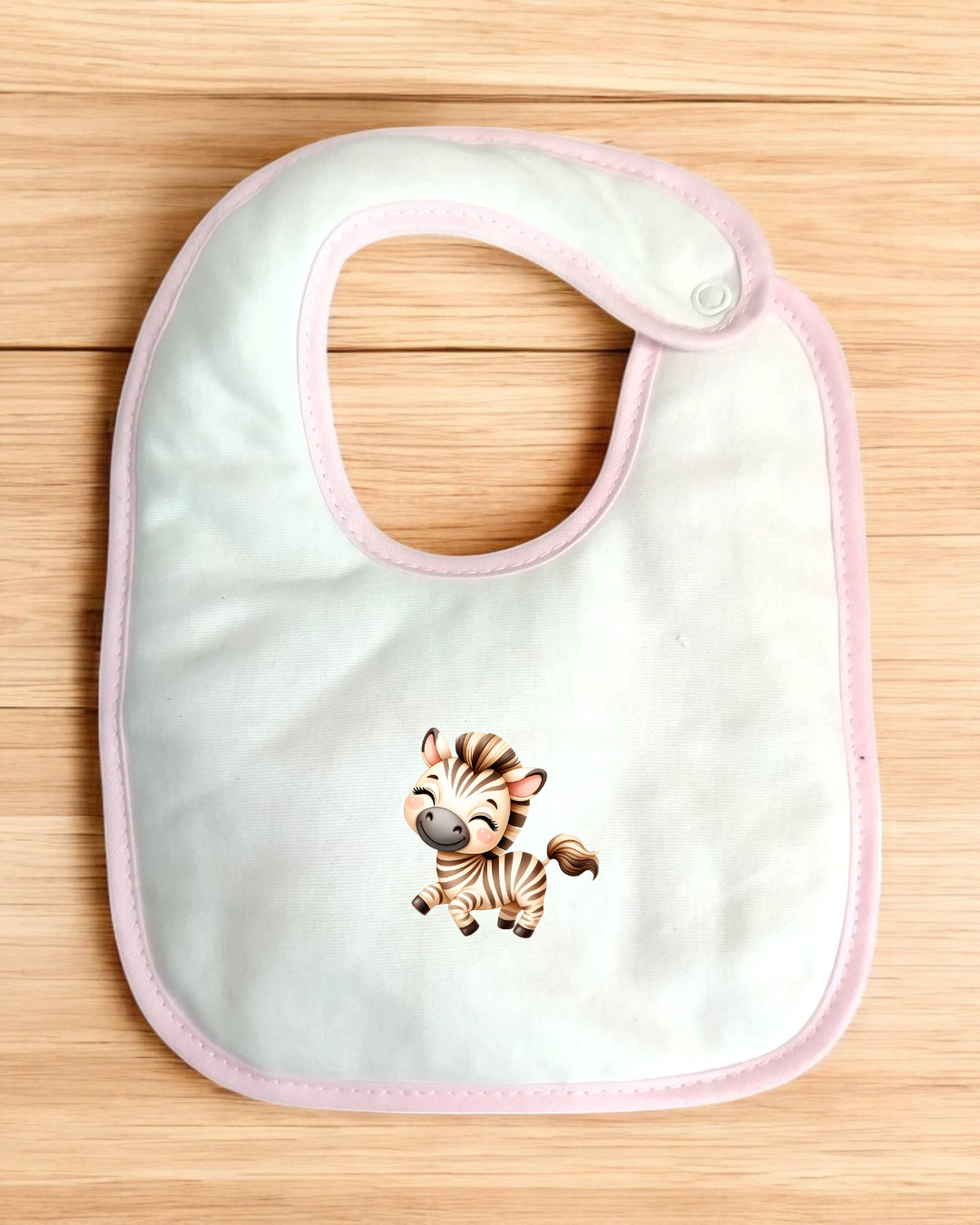 Babete branco com borda rosa e figura de zebra bebé