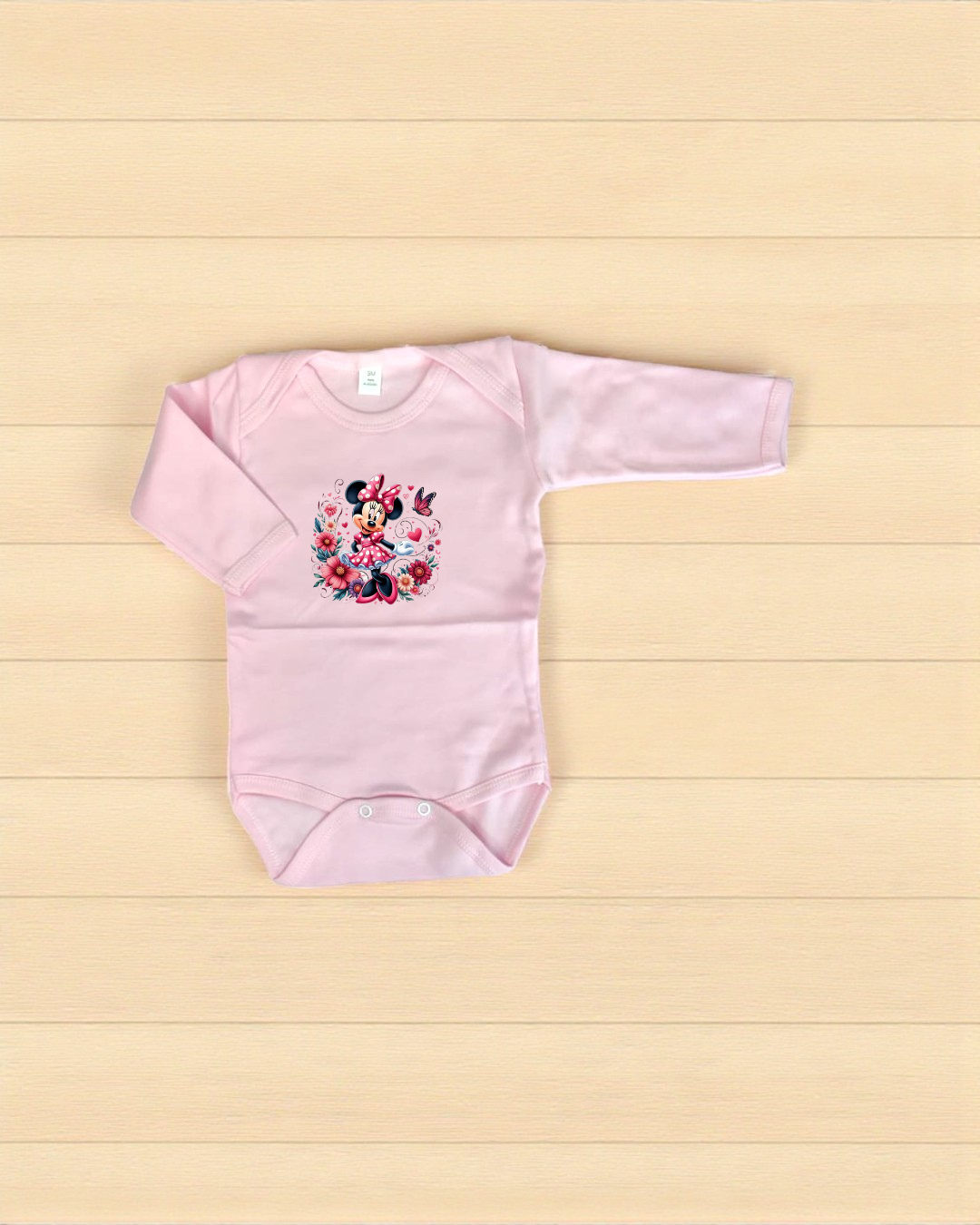 Body de bebé cor-de-rosa claro com estampa de Minnie Mouse e flores.