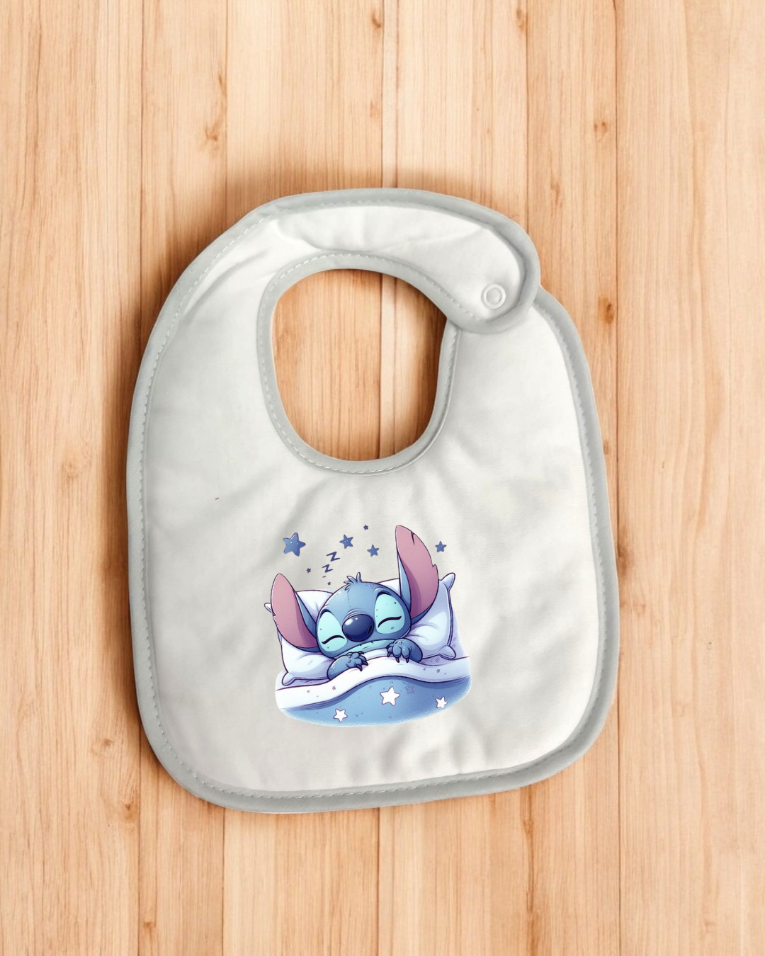 Babete branco com estampado de personagem azul a dormir