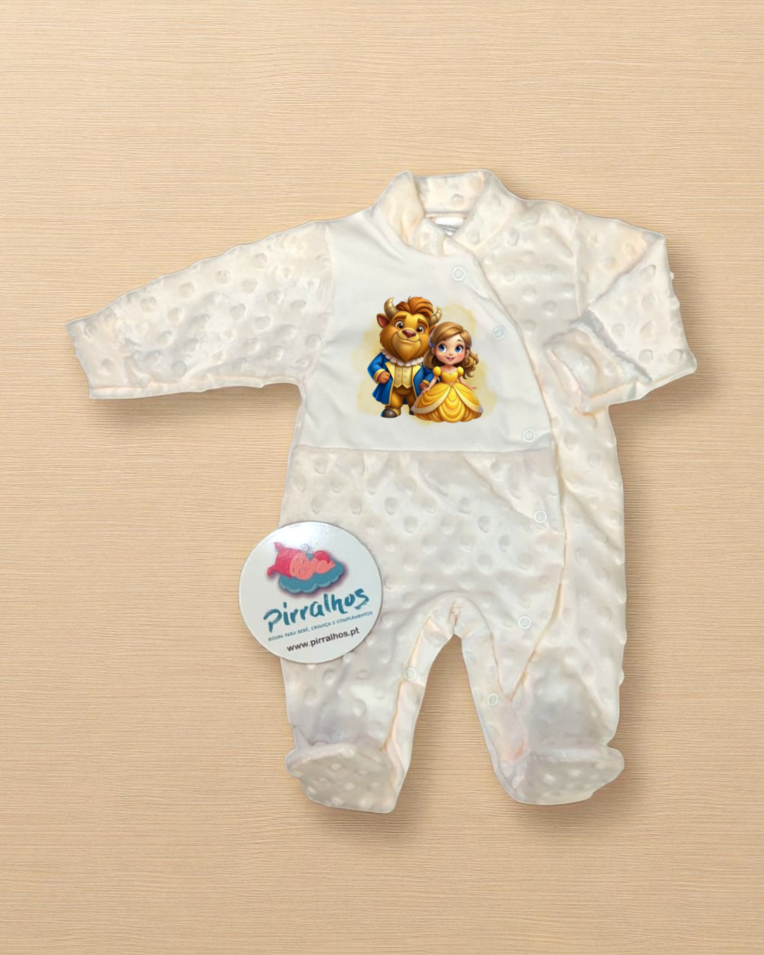 Macacão branco para bebé com estampado da Bela e o Monstro e etiqueta redonda da Piralhos.