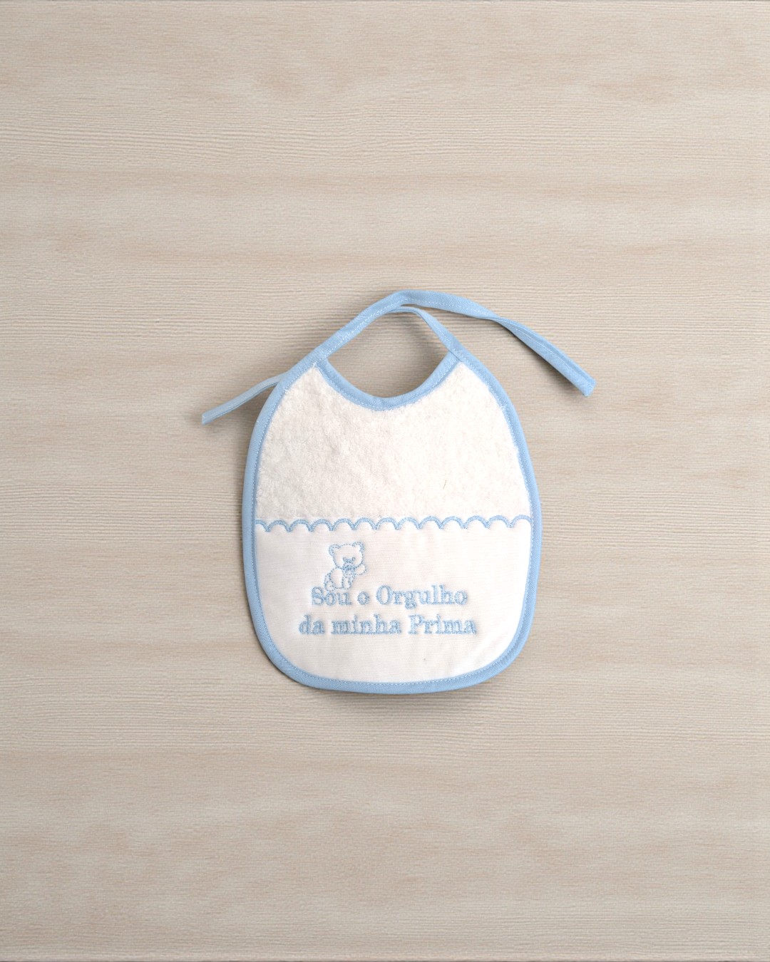 Babete de bebé branco com azul e bordado de urso e texto em azul
